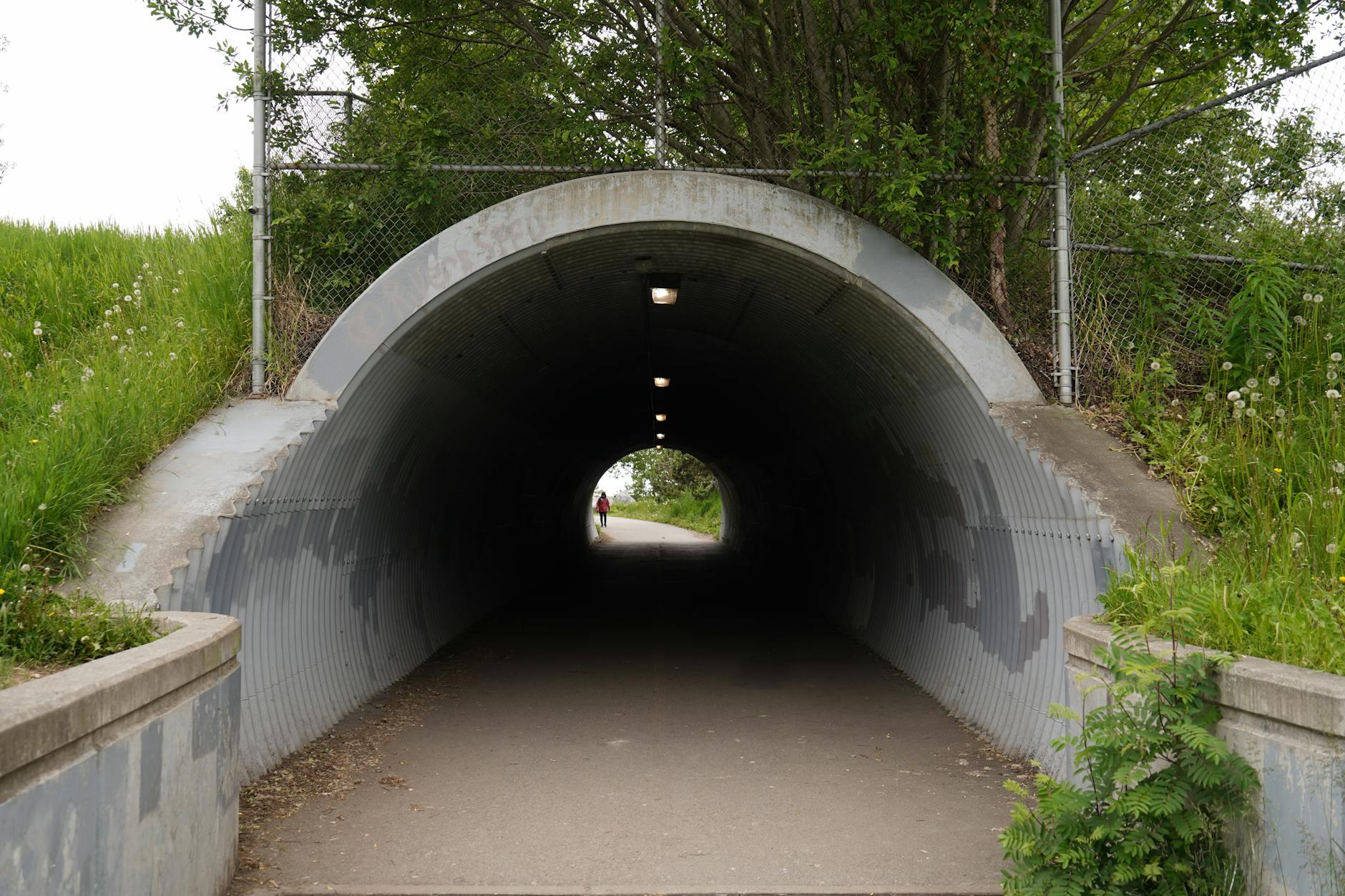 Entrance to an underground tunnel or bunker space, highlighting the unique venue access for fashion week attendees
