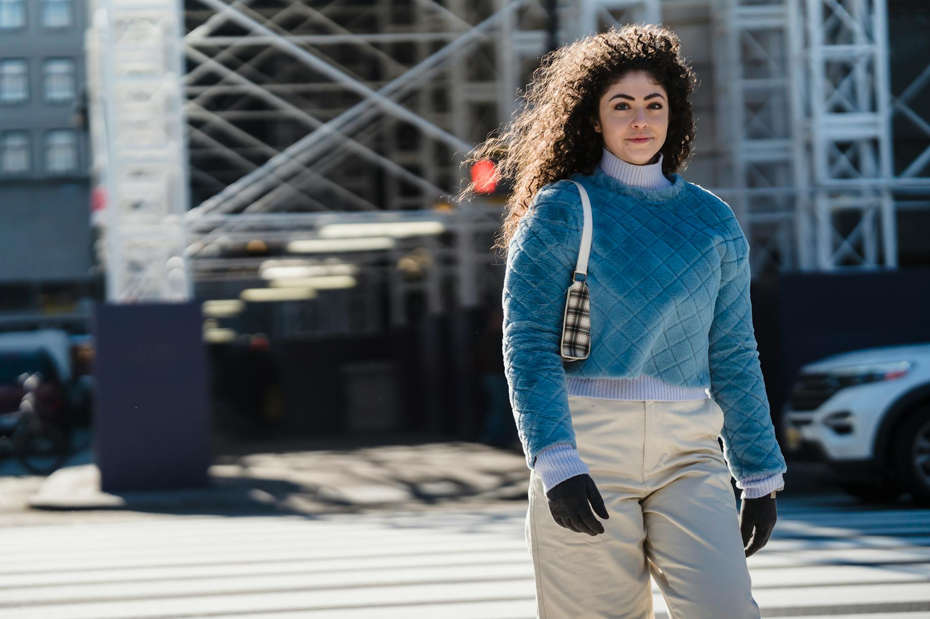 Person in casual street style outfit walking on urban sidewalk