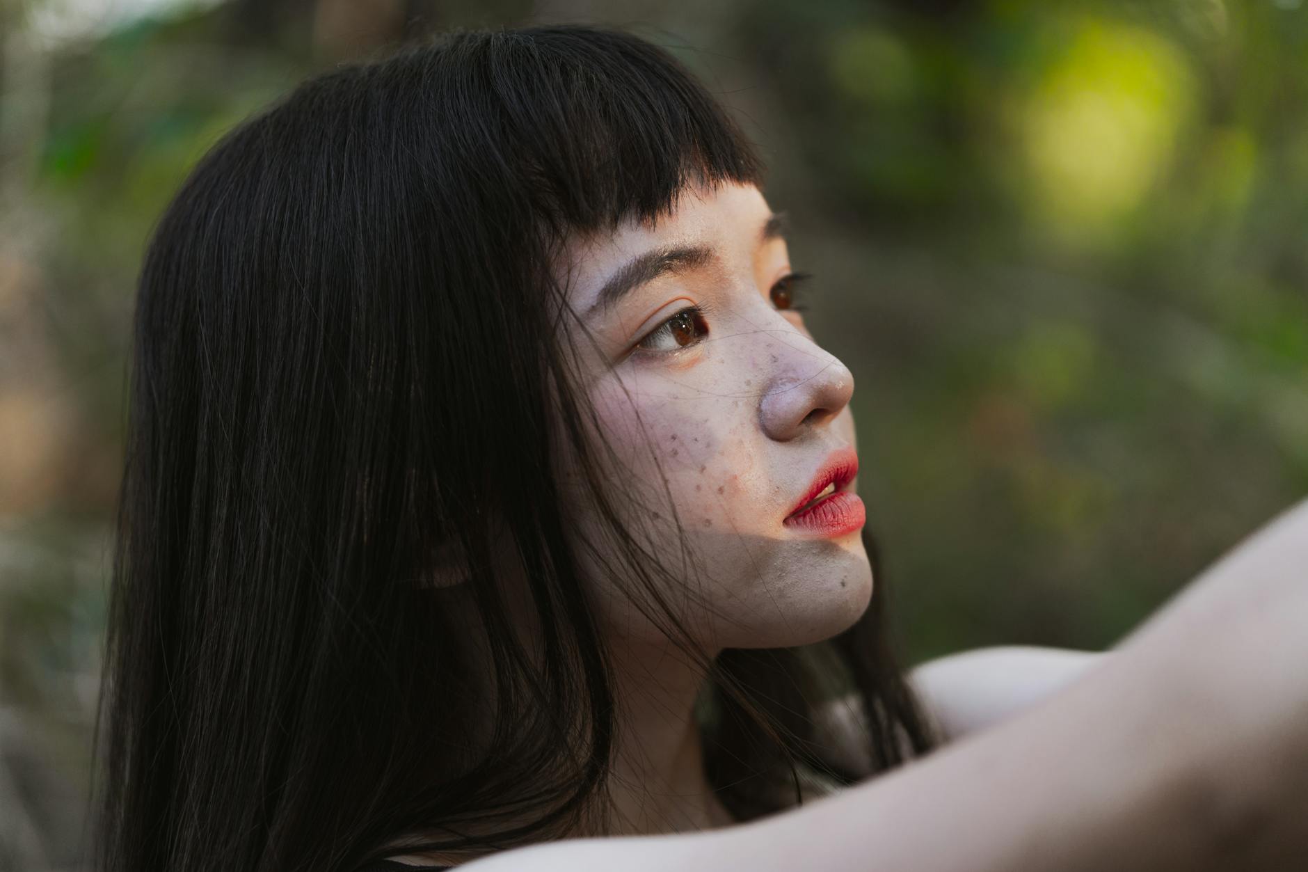Portrait of woman with dramatic eye makeup featuring bold geometric eyeliner design