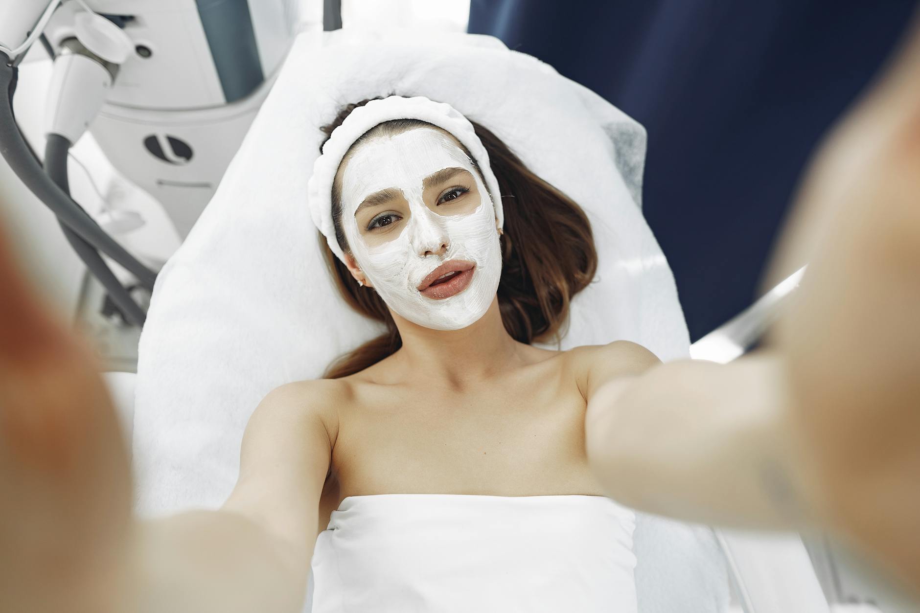 Woman receiving professional facial treatment with medical-grade skincare equipment