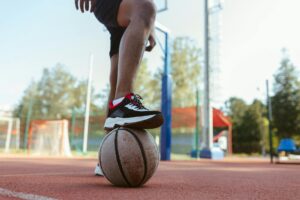 Professional basketball sneakers on wooden court surface