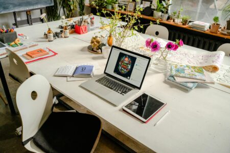 Artist working in creative studio space with sketches and design materials