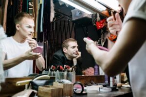 Peter Philips Crafts Film Noir Beauty for Dior Cruise Professional makeup artist applying cosmetics backstage at fashion show