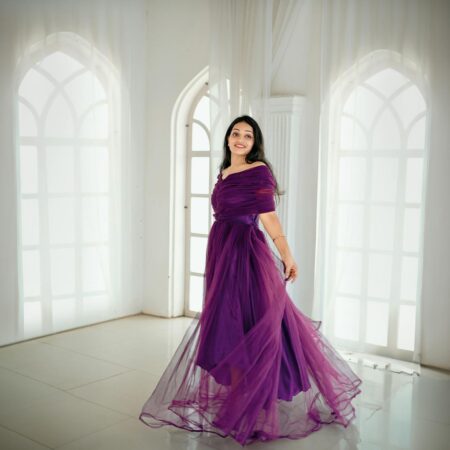 Model in a deep violet high-slit evening gown on a red carpet