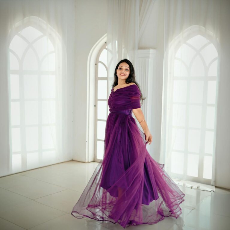 Model in a deep violet high-slit evening gown on a red carpet