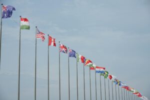 Two government officials shaking hands at a formal trade summit signing ceremony