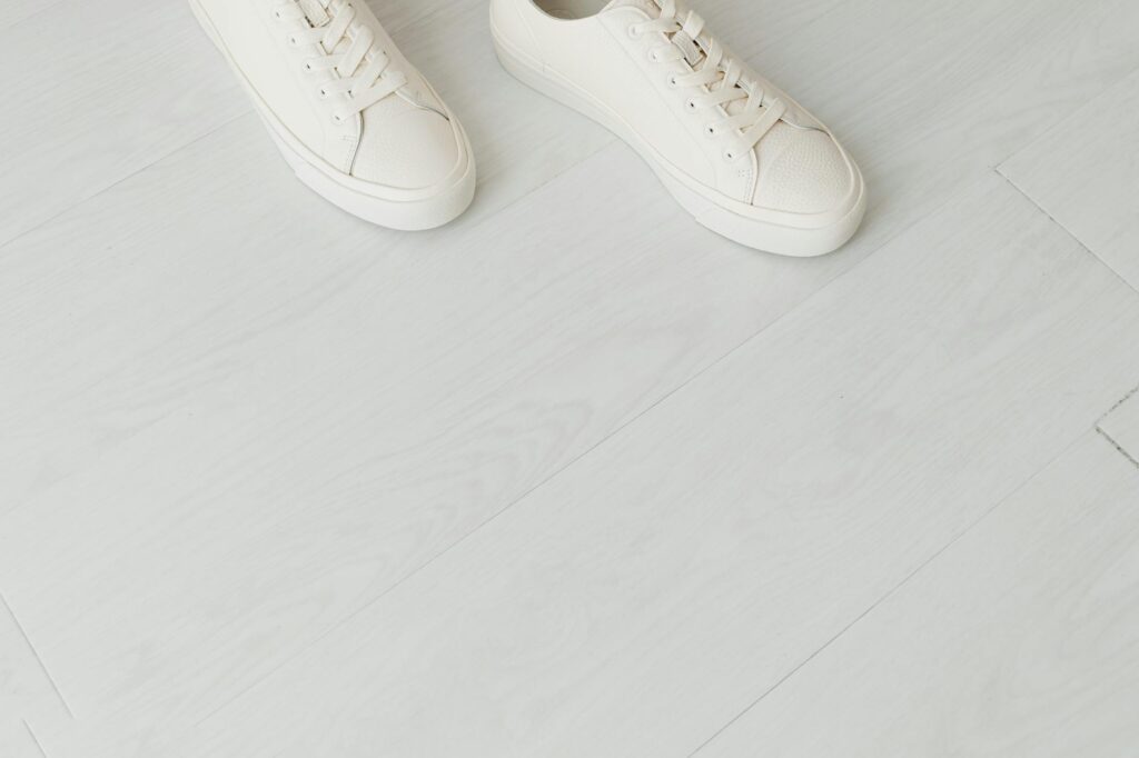White canvas low-top sneakers on a clean surface