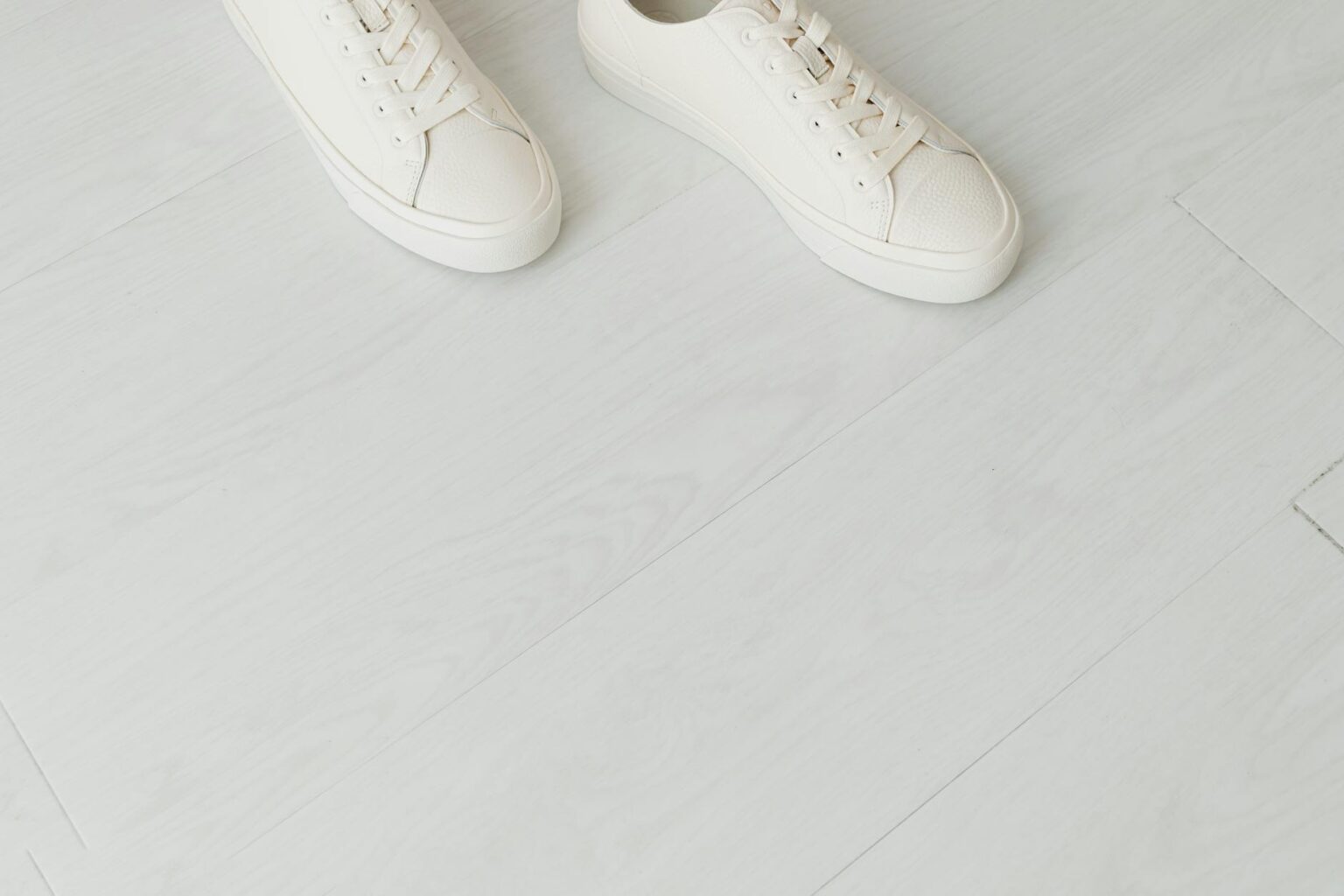 White canvas low-top sneakers on a clean surface