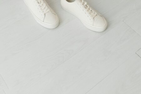White canvas low-top sneakers on a clean surface