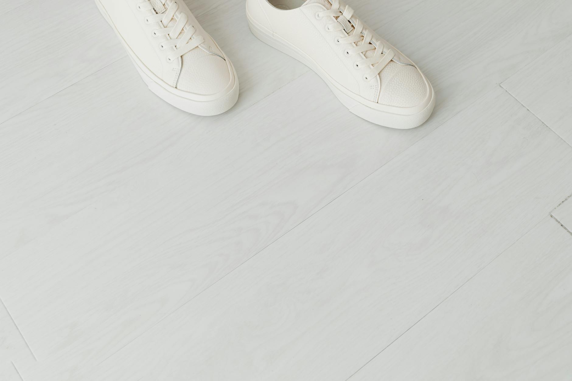 White canvas low-top sneakers on a clean surface