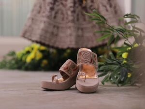High-end designer sandals displaying innovative heel construction and artistic design elements