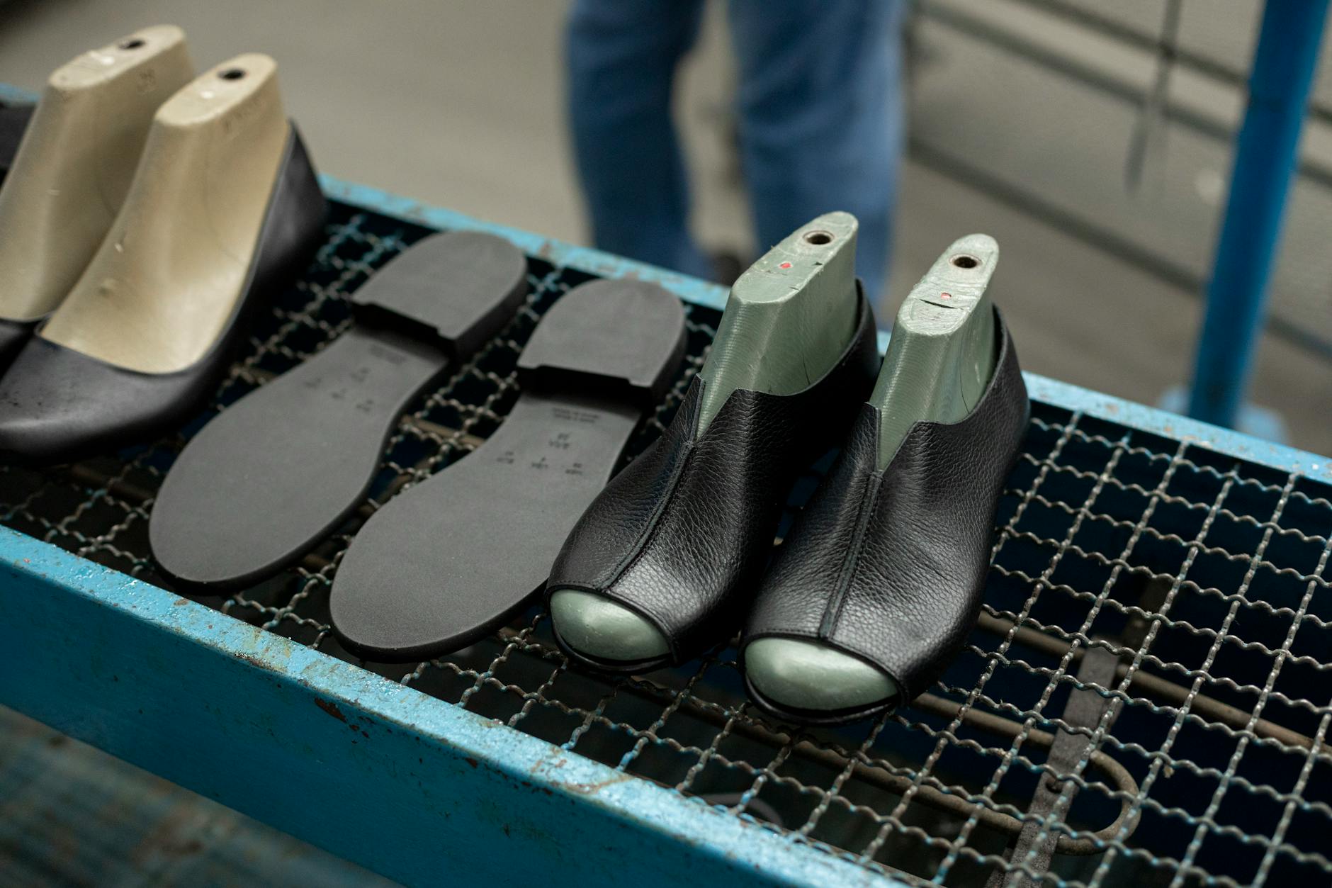 Footwear production facility showing specialized tools and equipment for custom shoe construction