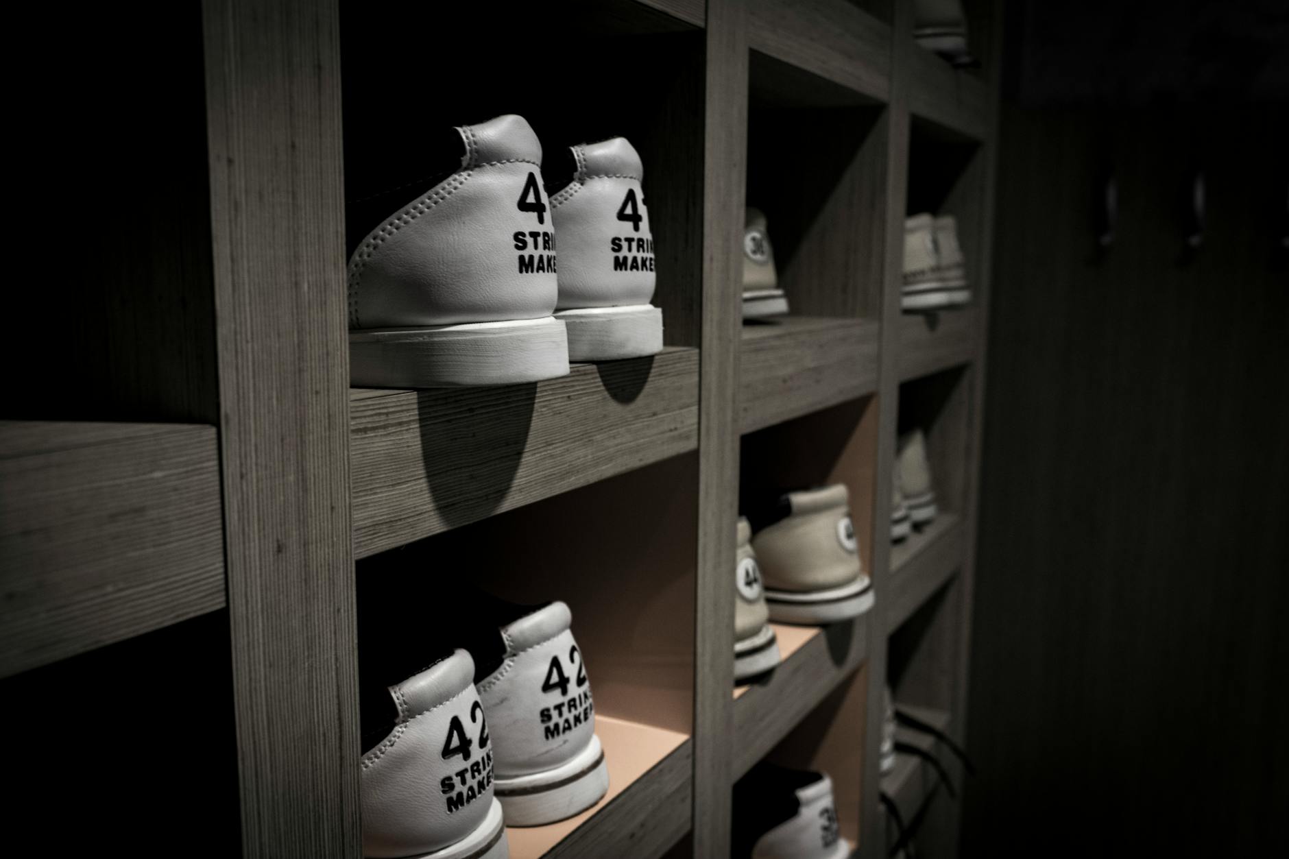 Dark green athletic sneakers arranged on retail display shelf