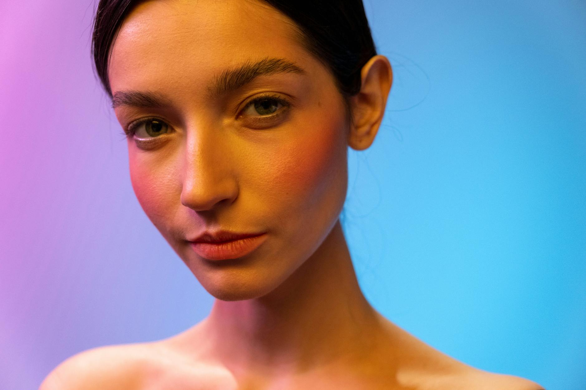 Woman with radiant flushed cheeks and natural makeup finish in warm light