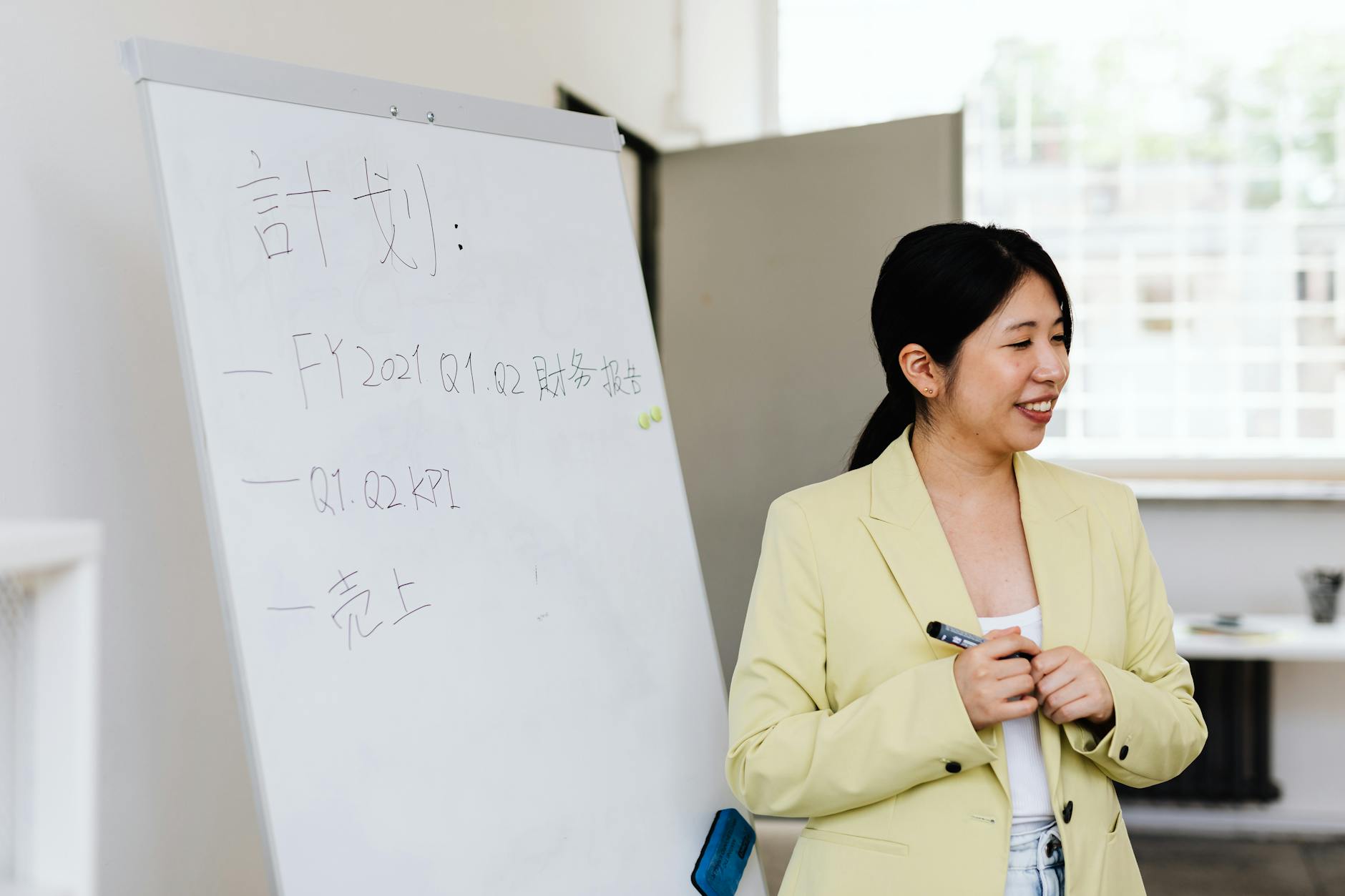 Business woman reviewing plans and documents at organized workspace