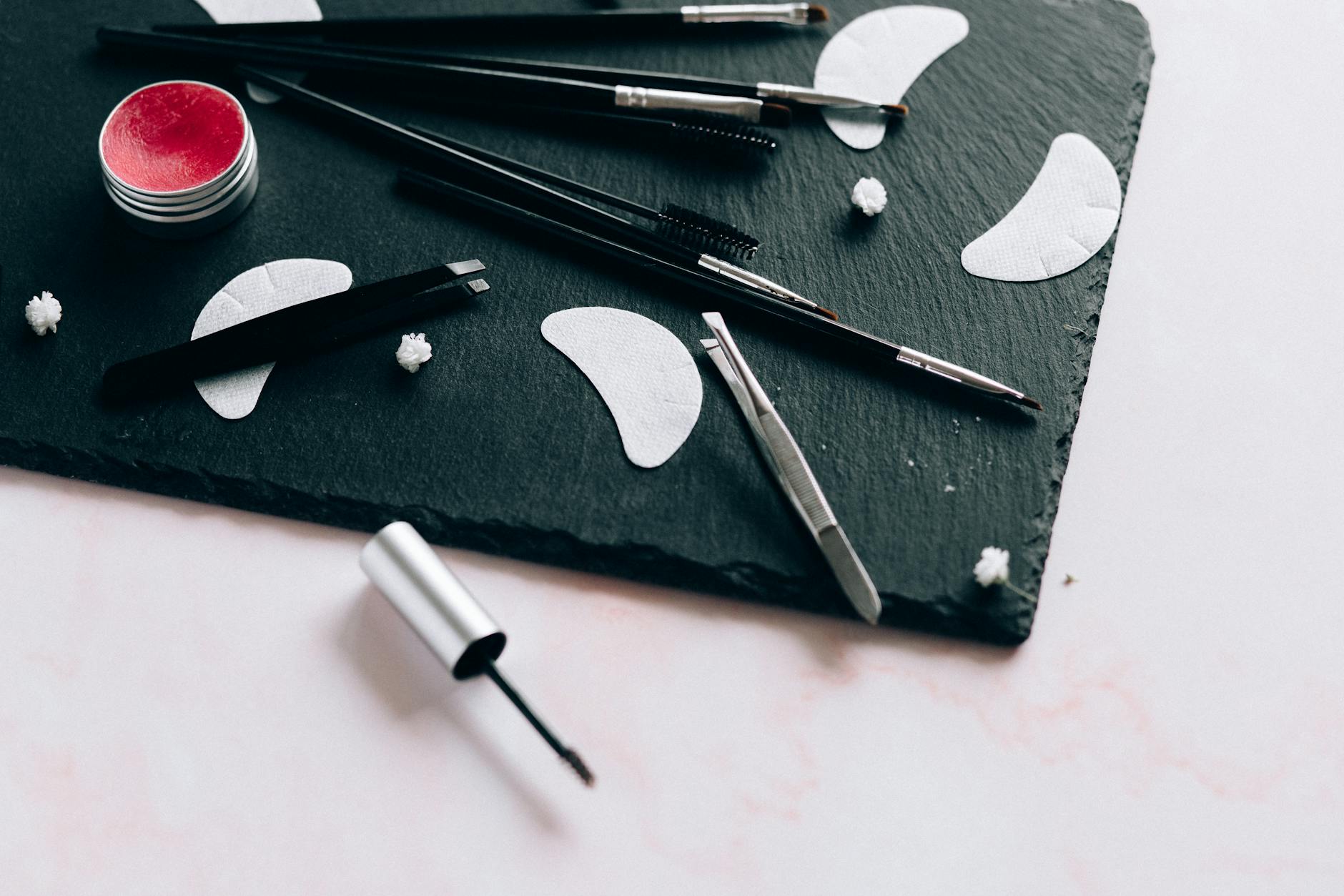 Beauty products and accessories arranged on clean white surface