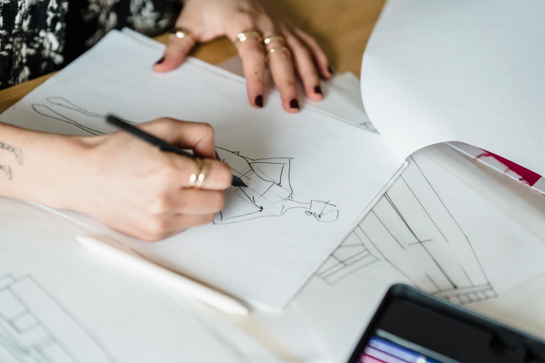 Fashion designer sketches and design materials on work table