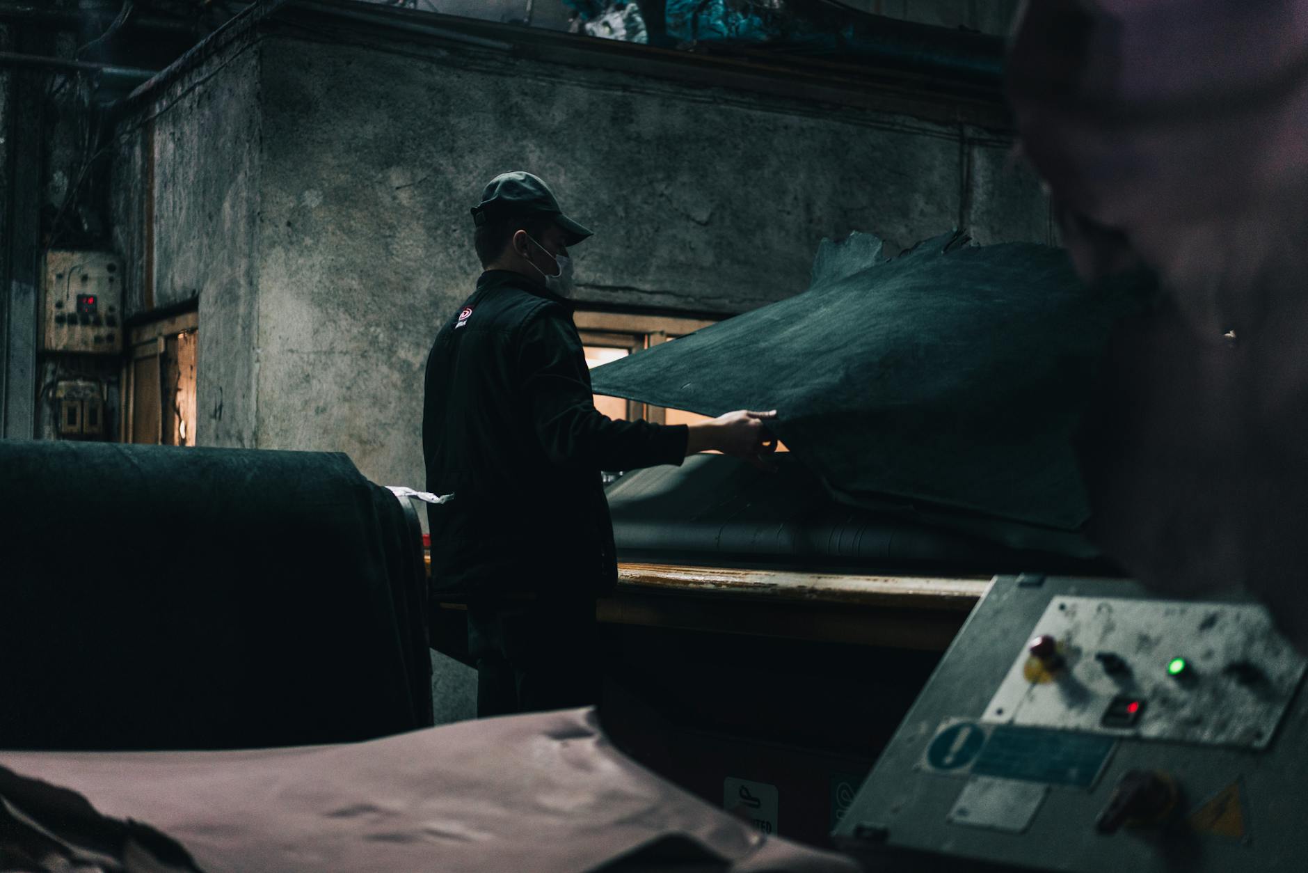 Skilled artisan working with premium leather materials in workshop