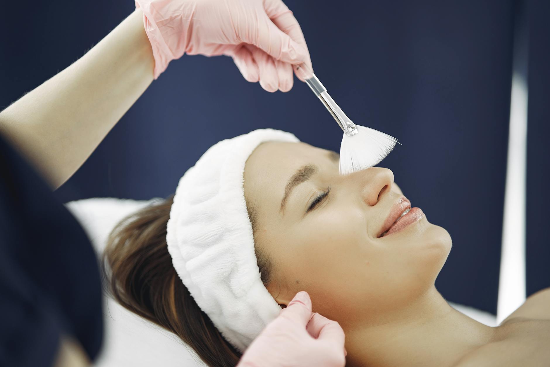 Professional skincare treatment being applied to woman's face in clinic setting
