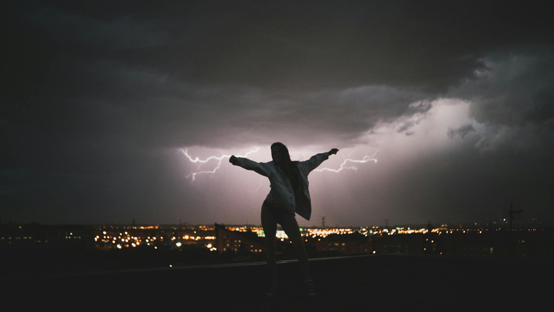 Strong female silhouette against dramatic backdrop representing empowerment
