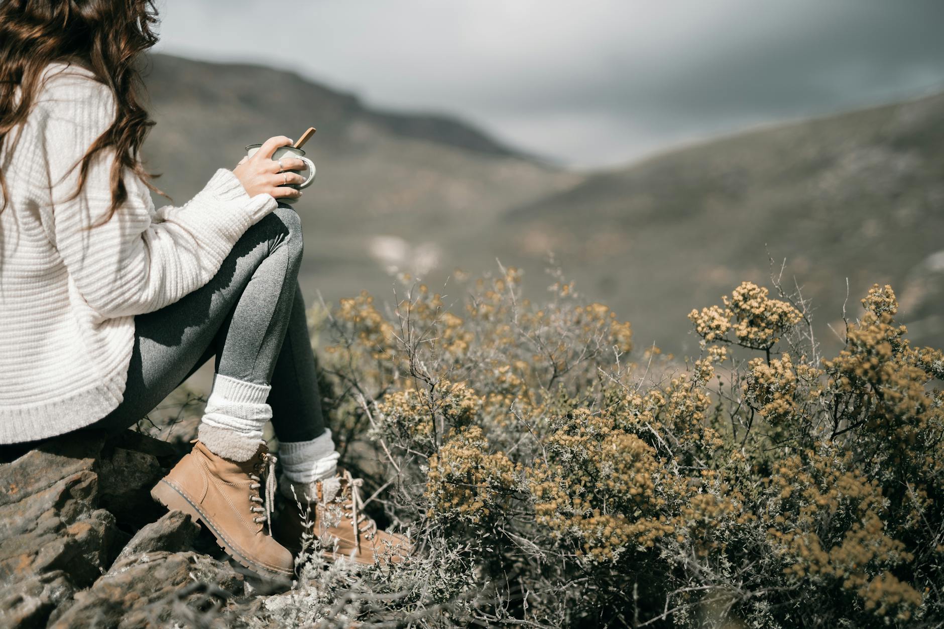 Professional hiking boots and mountaineering equipment on rocky terrain