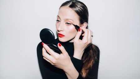 Professional makeup brushes and beauty tools arranged on clean surface