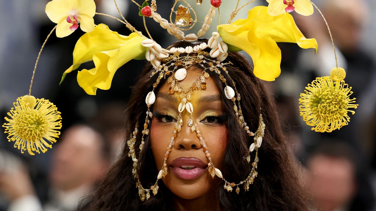 Close-up of luminous golden makeup highlighting technique on model's face