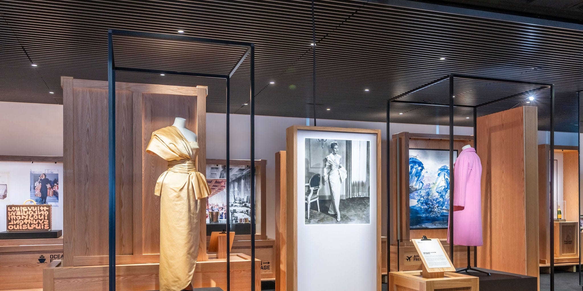 Historical fashion archive objects arranged in a museum exhibition setting