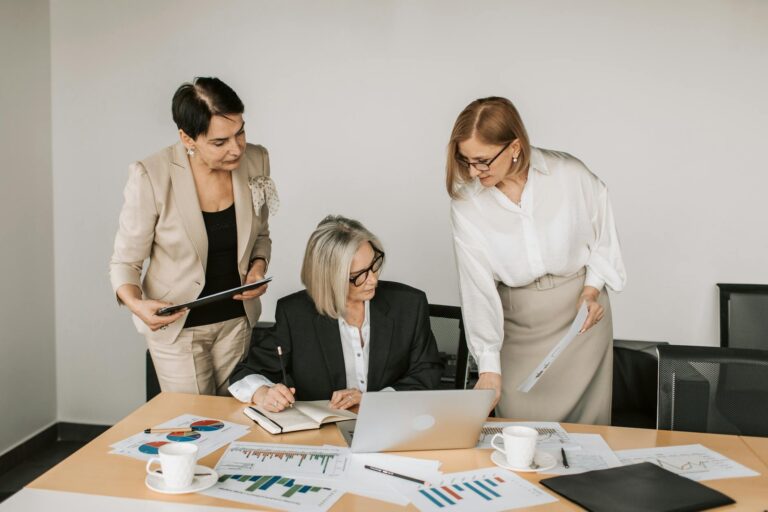 FN Names Its Women Who Rock Class of 2026 Group of professional women in a modern business setting representing female leadership in the footwear industry