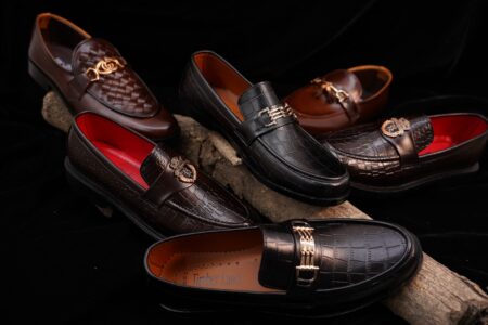 Close-up of luxury men's dress shoes on a runway surface