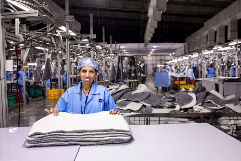 A worker handling raw materials in a production facility