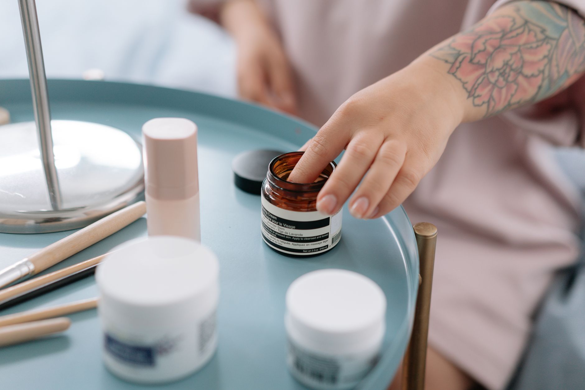 High-end skincare cream jars displayed on a marble surface