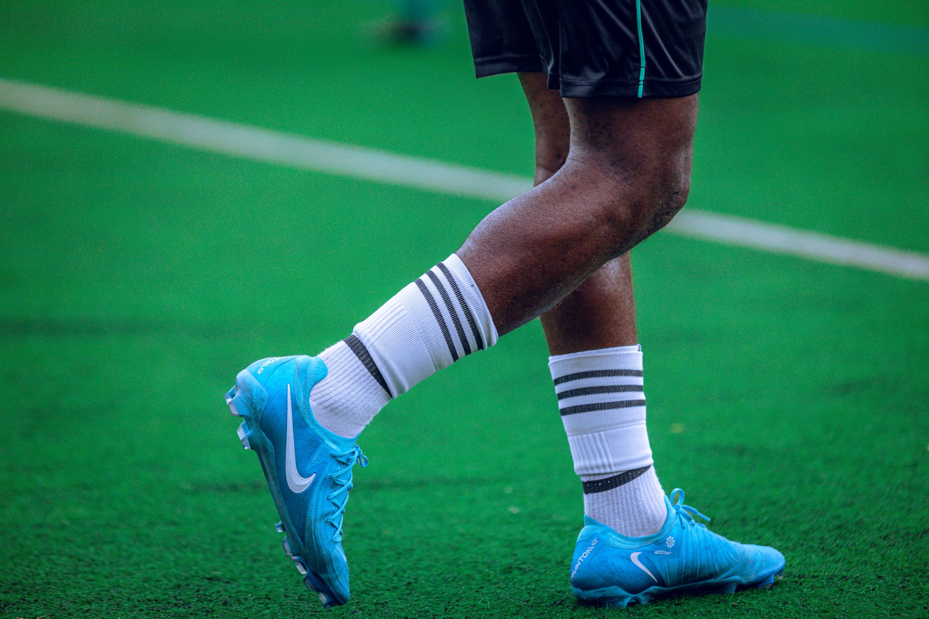 Soccer cleats placed on grass representing football boot heritage