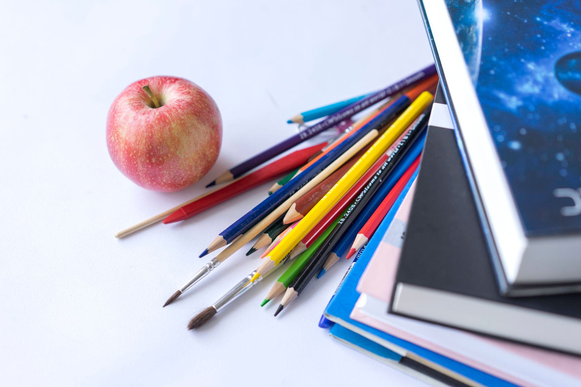 Colorful school supplies including notebooks and accessories laid flat on a desk