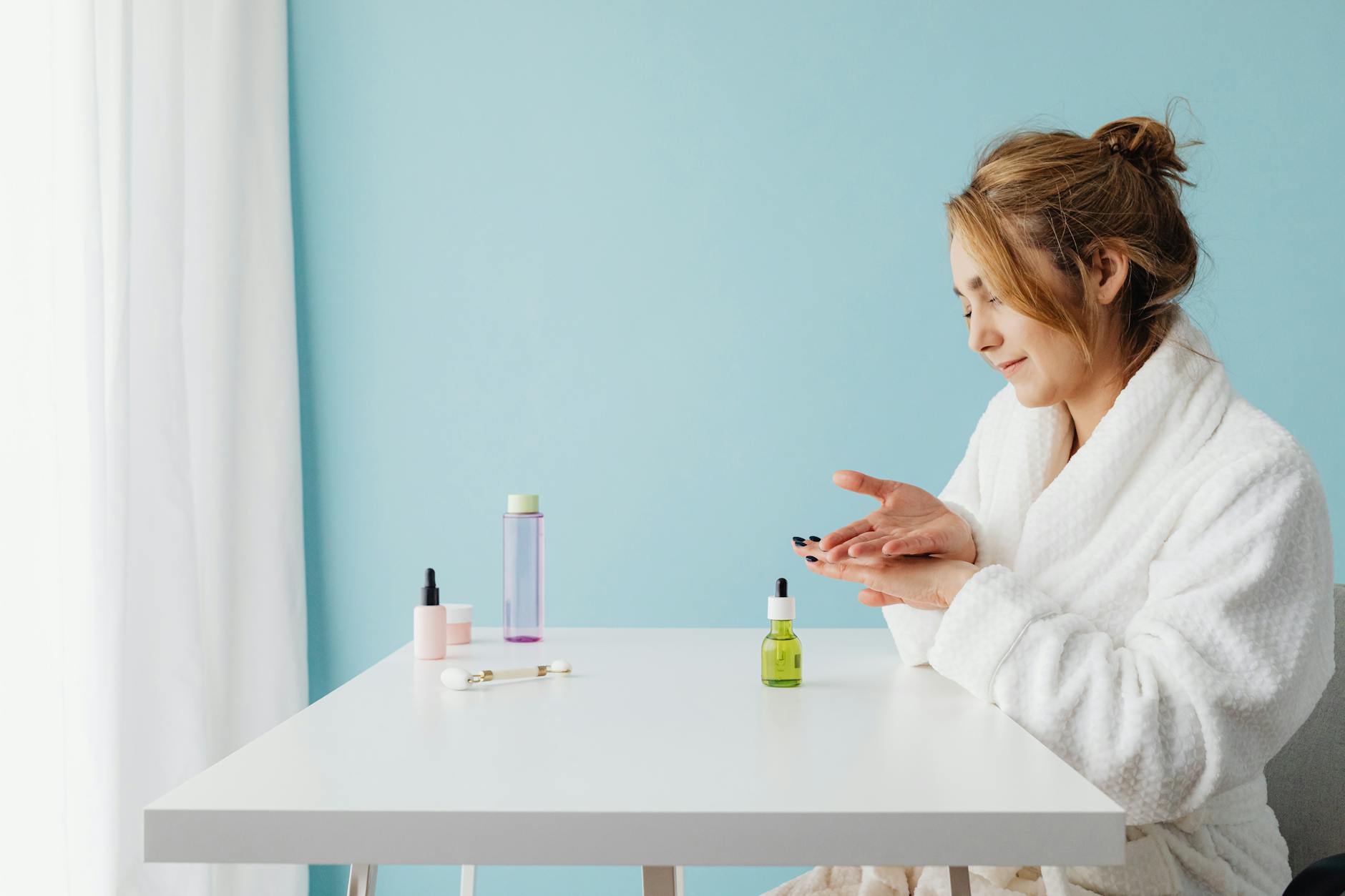 Skincare products including SPF and serums arranged on a bathroom counter