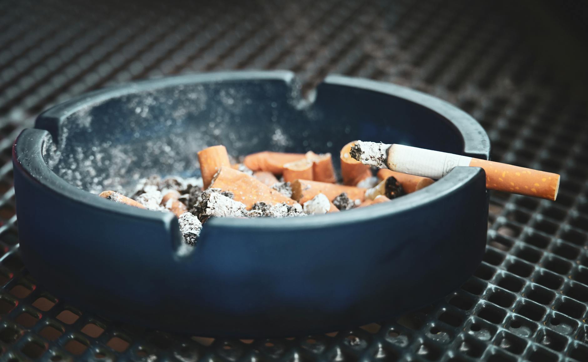 Close-up of cigarette smoke drifting against a dark background