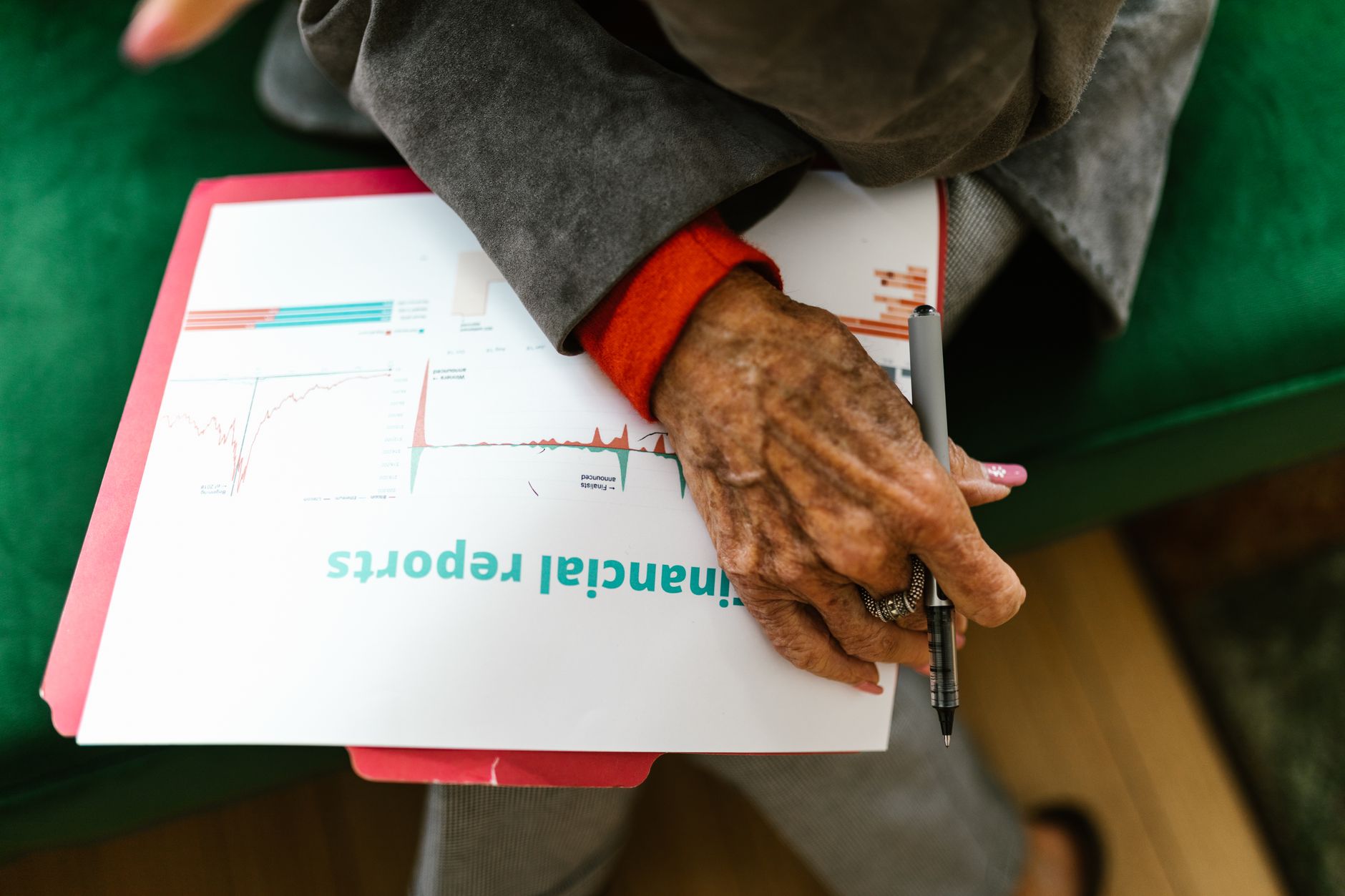 Financial paperwork and charts spread across a business desk