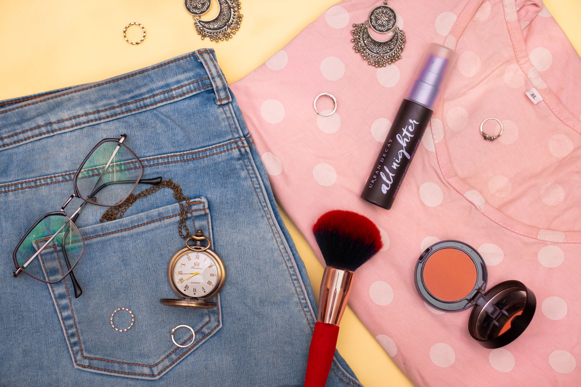 Assorted complexion makeup and skincare products arranged on a neutral background