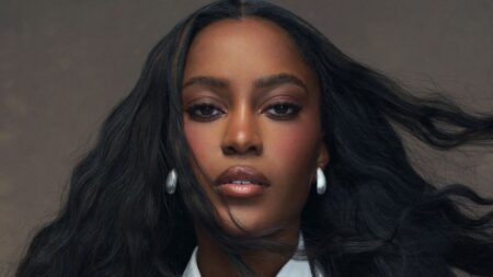 Woman with polished makeup and styled hair ready for a television appearance