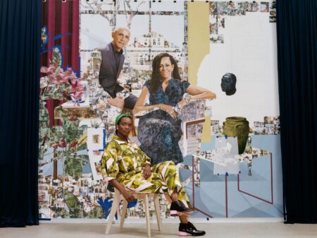 Artist working on a large-scale portrait painting in a studio