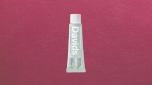 Premium toothpaste tube displayed on a clean marble bathroom counter