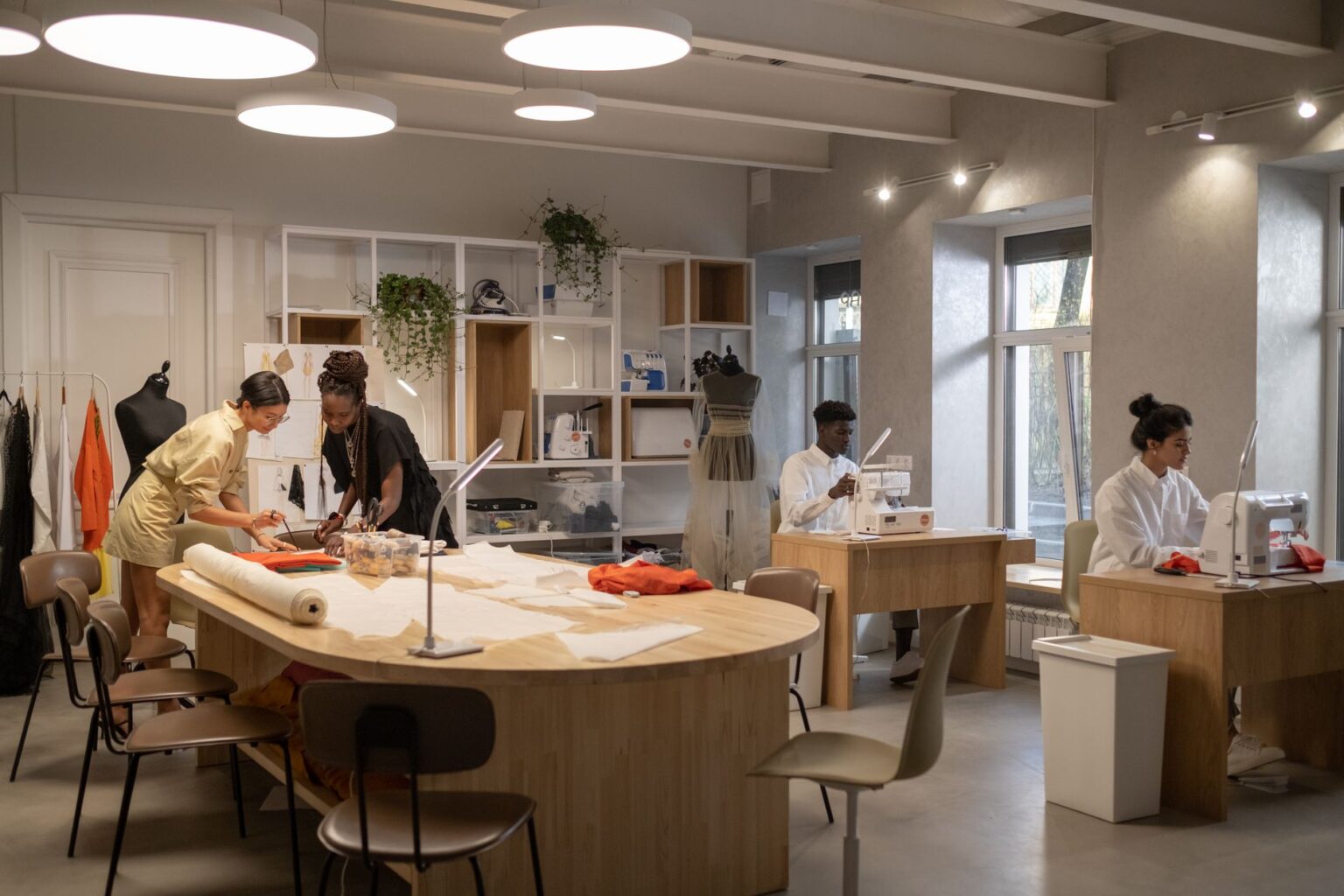 Chanel Ends Product Destruction, Routes Unsold Goods Through New Circular Units Interior of a high-end fashion atelier with fabric materials and workbenches