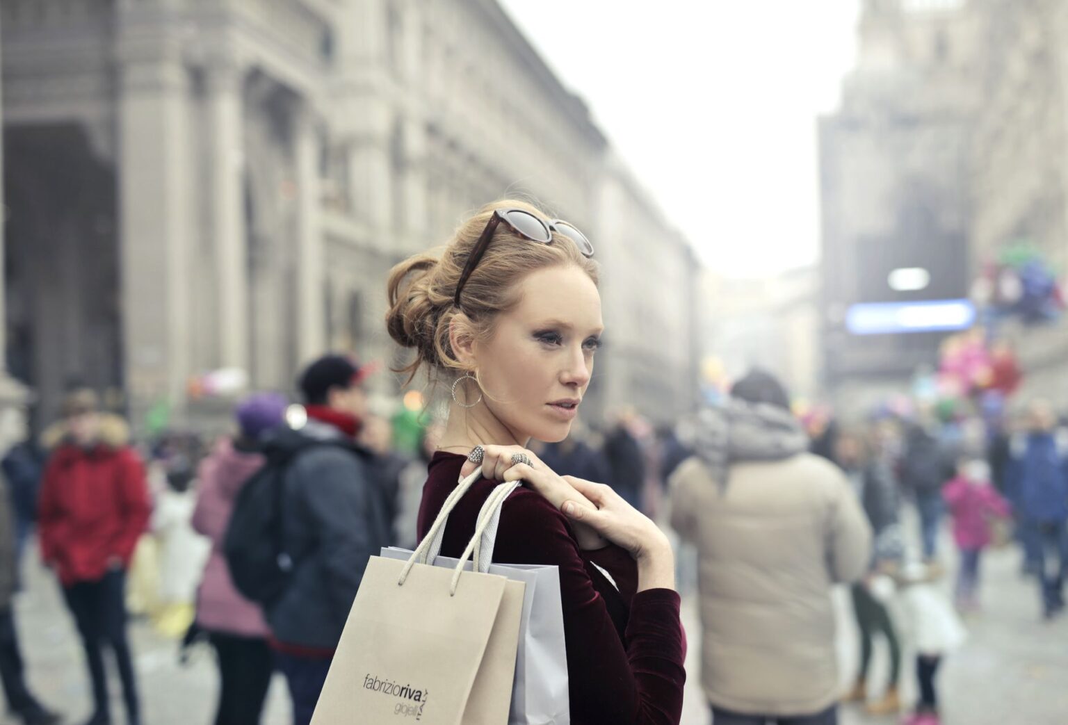 Shoppers walking along a fashion retail street in Milan's Brera district