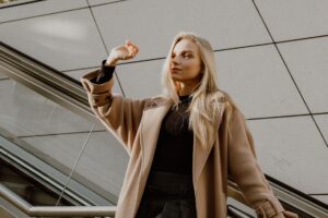 Max Mara Turns 75 With Reissued Coats and a Family Reckoning A woman wearing a tailored camel wool coat, representing Max Mara's signature outerwear aesthetic