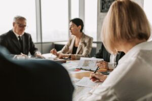 Executives in a corporate boardroom discussing company policy