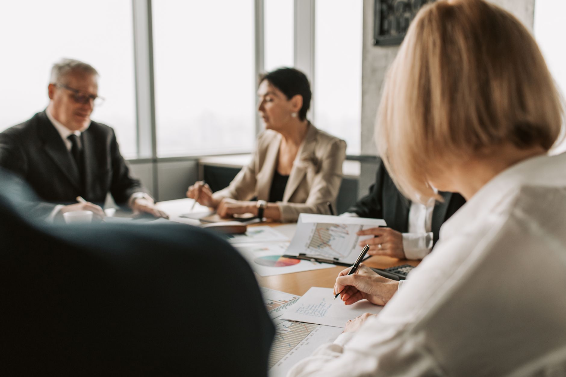 Executives in a corporate boardroom discussing company policy