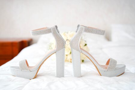 Taylor Swift Wears Custom Louboutin Heels for Kelce Wedding Custom white bridal heels displayed on a clean surface for a formal wedding ceremony