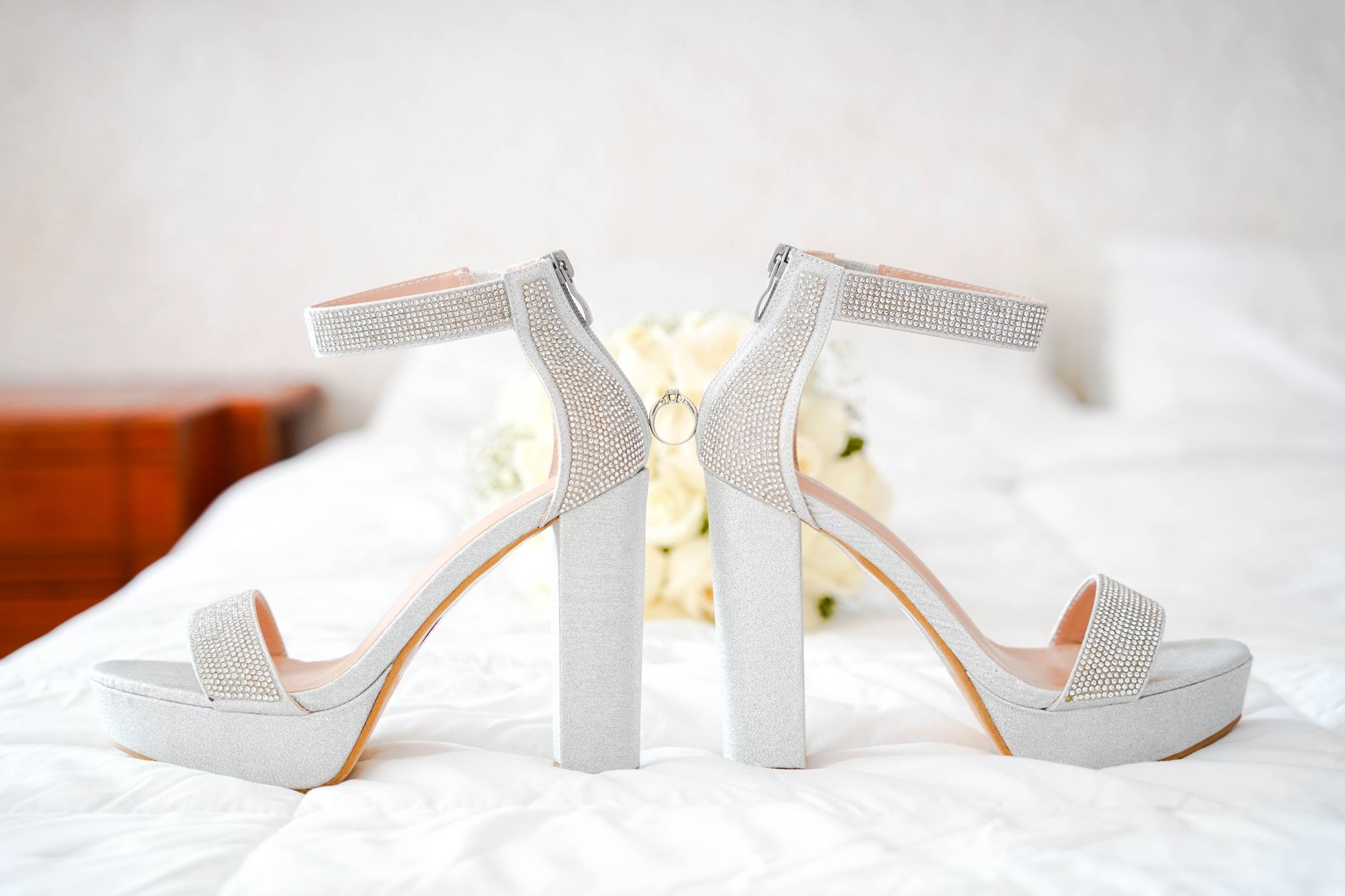 Custom white bridal heels displayed on a clean surface for a formal wedding ceremony