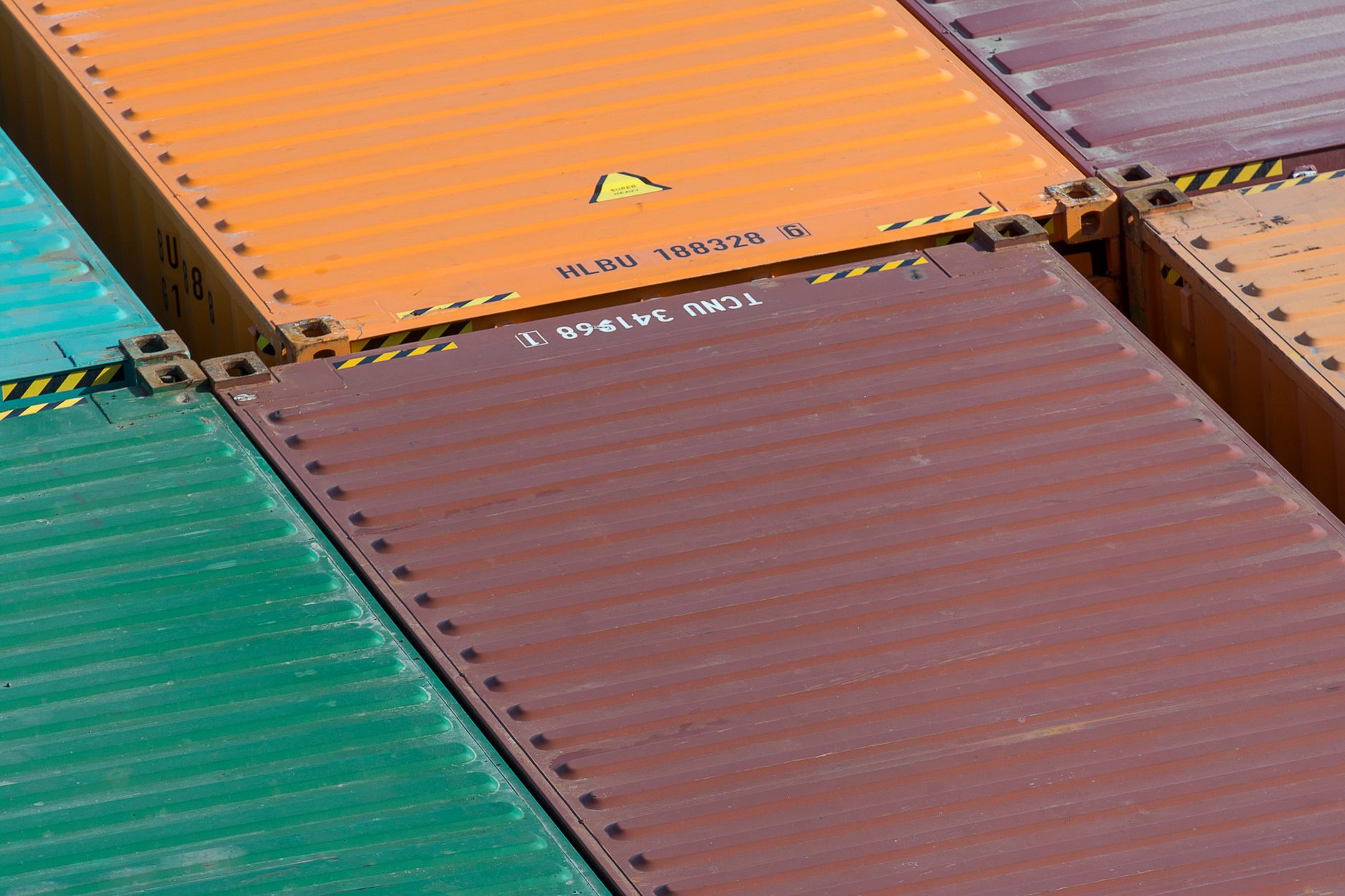 Large shipping containers stacked at a port terminal