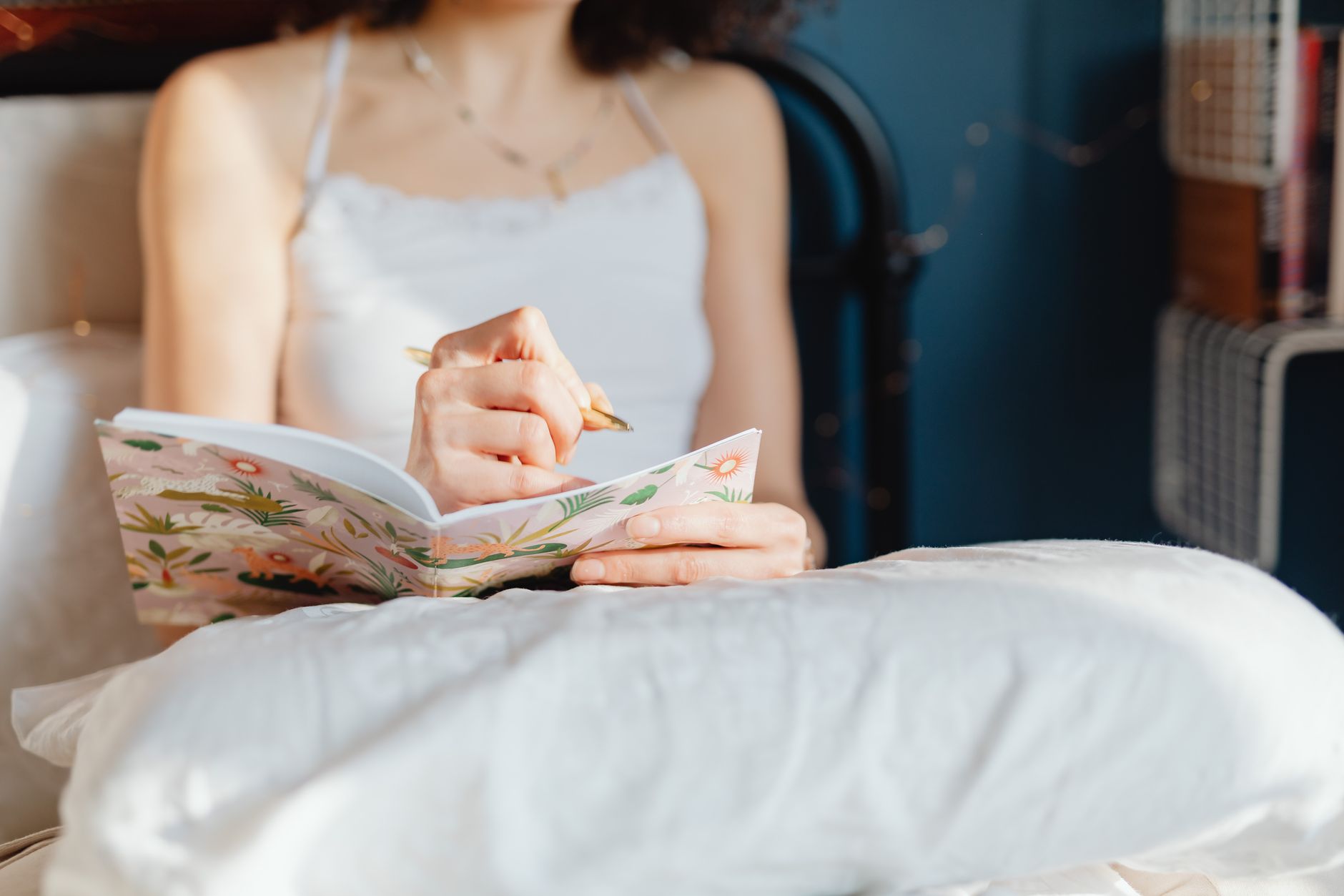 Woman writing in a journal during a quiet morning ritual